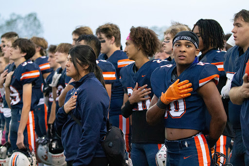While playing at CBAC, Olathe East senior running back Daylan Mburu breaks his way through the defense team from Lawrence High to score the first touchdown for Olathe East high school of the night. “When I was first running on the field I was nervous, And after that my nerves just went away and I started doing my thing.” Mburu said. The Hawks defeated the Lions 24-6